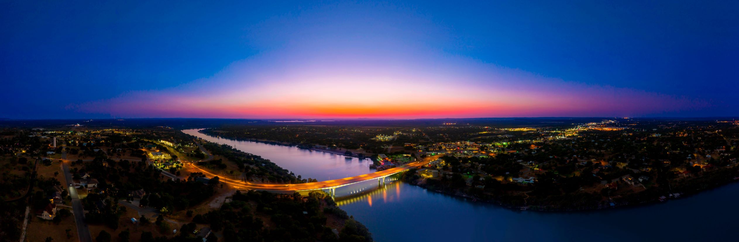 A gorgeous sunset falls on the bridge over Lake Marble Falls
