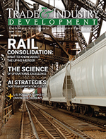 Magazine cover titled "Trade & Industry Development" with a focus on rail consolidation. Shows rail tracks and freight trains in an industrial setting.