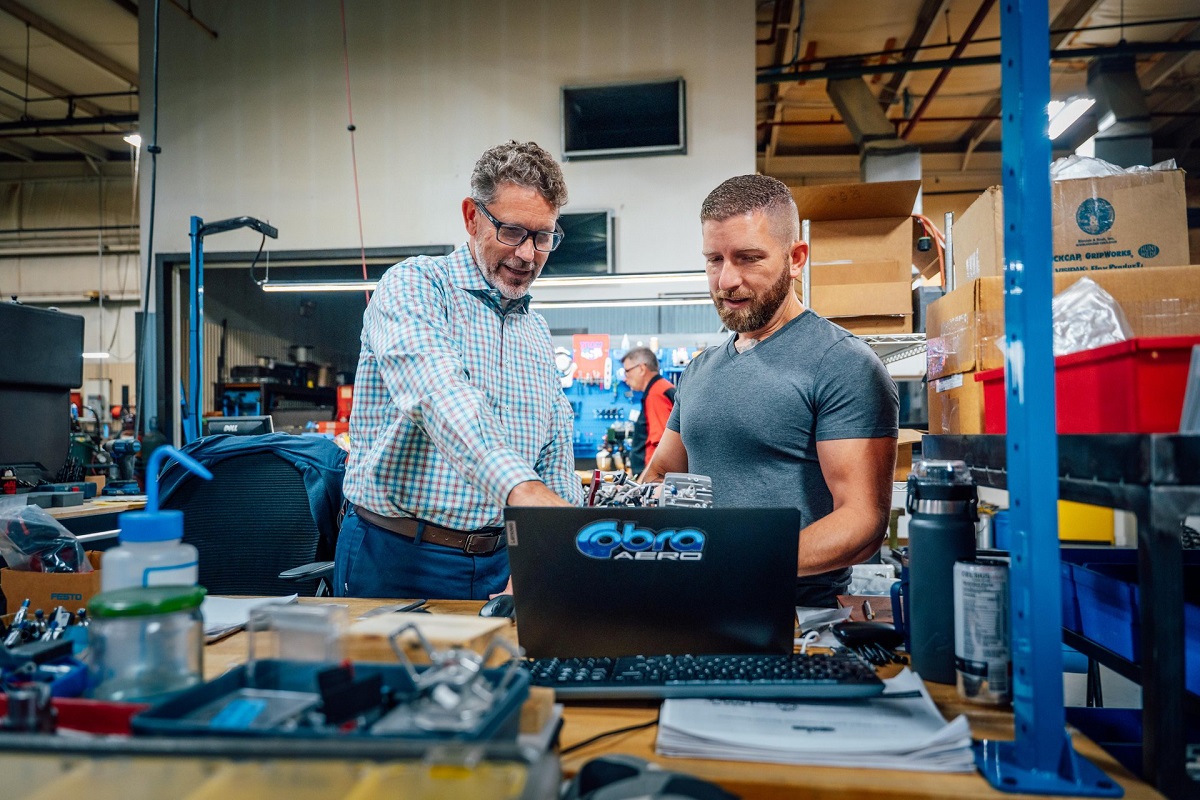 Aerospace engineers review aircraft component designs in a Michigan advanced manufacturing facility.
