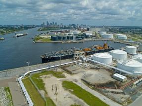 Aerial view of Port Tampa Bay showing cargo terminals, fuel storage tanks, liquid bulk facilities, and ships supporting global trade and logistics.