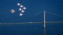 Military aircraft fly over Michigan's Mackinac Bridge, highlighting the state's aerospace and defense industry leadership. Military aircraft fly over Michigan's Mackinac Bridge, highlighting the state's aerospace and defense industry leadership.