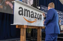 Governor Tate Reeves signs a ceremonial steel beam during Amazon's announcement that it is increasing its Mississippi investment to $25 billion. 