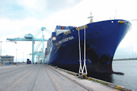 Cargo container ship being unloaded.