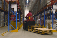 Moving pallets in warehouse.