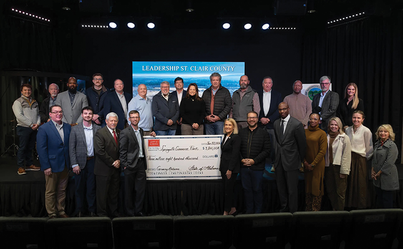 Group of people standing behind a large check for "$3,800,000" for Springville Commerce Park at a Leadership St. Clair County event.