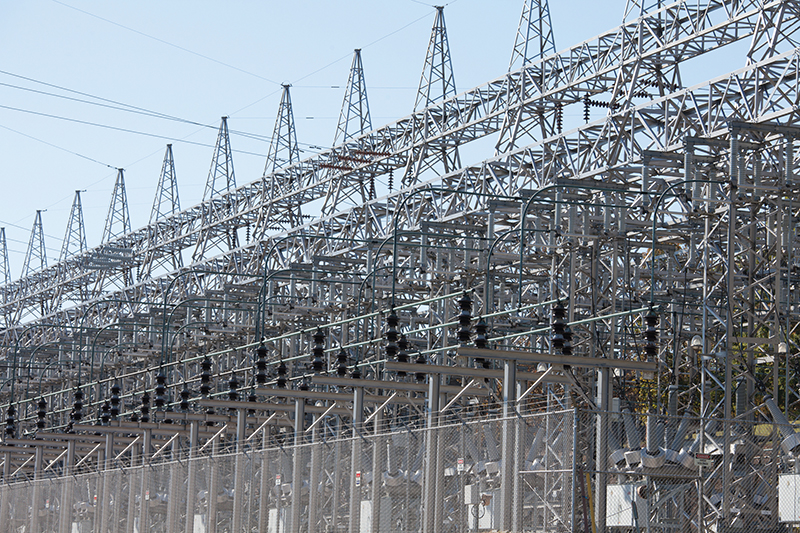 A large electrical substation with multiple power lines and transformers.