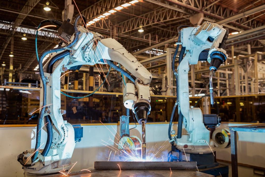 Industrial robot is welding assembly steel part in car factory.