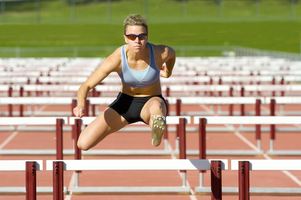 woman running hurdles
